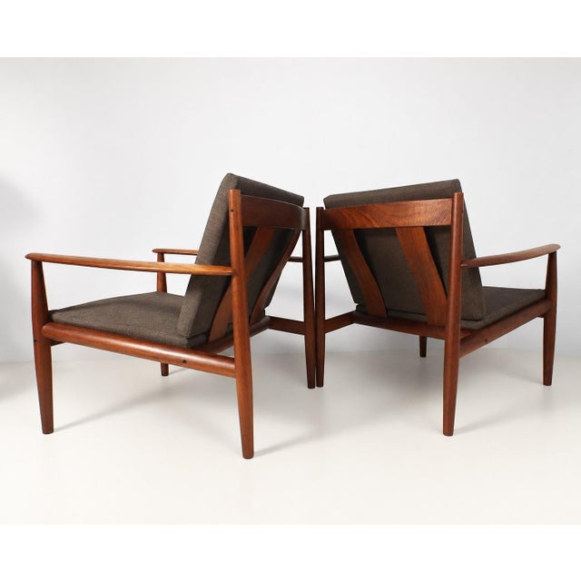 Elegant Pair of Danish lounge chairs, model FD118, designed by Grete Jalk for France & Søn in the 1960s. Crafted from...