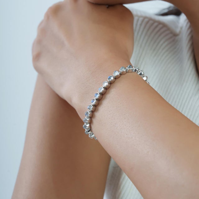 Handmade Round 9.1 Ct Rainbow Moonstone Bezel Set Infinity Line Tennis Bracelet in 925 Silver For Sale - Image 10 of 14