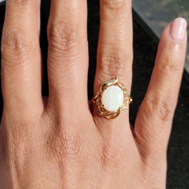 Stone: Australian Opal Stone Cut: Round Band Material: 14k Yellow Gold Weight: 3 grams **Due to the uniqueness of the opal...