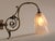 Art Deco wall lamp with brass bracket and etched glass shade featuring an Art Deco motif. Signed "Hubens". Very good...
