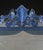 A very decorative late 19th century venetian mirror with blue glass borders, engraved crest and semi elliptical interior...