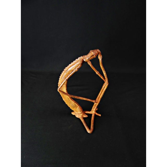 Dogon Nommo crocodile statue in bronze with brown patina and red highlights, mid-20th century What if you brought the...