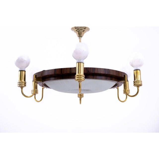 Art Deco chandelier, Poland, 1950s. A wonderful combination of different materials: wood, metal and glass. The lamp has...