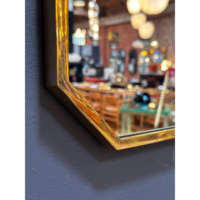 "A stylish Mid Century Italian octagonal wall mirror from the 1980s, exuding the classic design aesthetics of the era with...