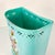 A beautiful Aqua Turquoise hand-painted flora design Metal Wastebasket from the 1950s. The colors are stunning and even...