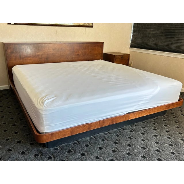 This sculptural mid-century modern walnut platform bed blends timeless design with functional elegance. Crafted with a...