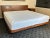 This sculptural mid-century modern walnut platform bed blends timeless design with functional elegance. Crafted with a...