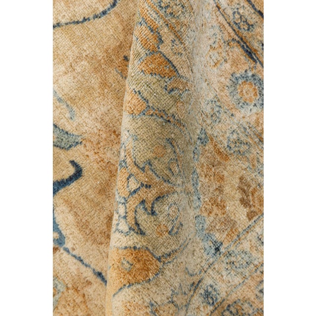 A finely-knotted early 20th century Persian Tabriz rug, the ochre field with allover dense rows of fleurons surrounding a...