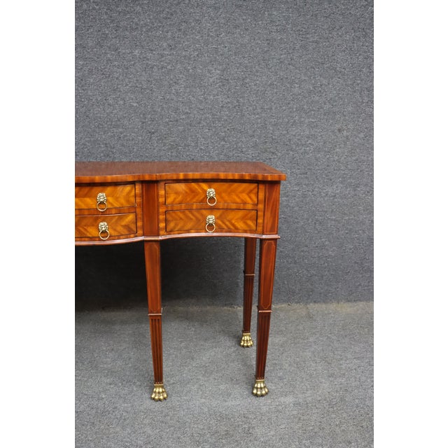 Elegant Maitland-Smith console table crafted in richly figured mahogany with striking satinwood-style banding and chevron-...
