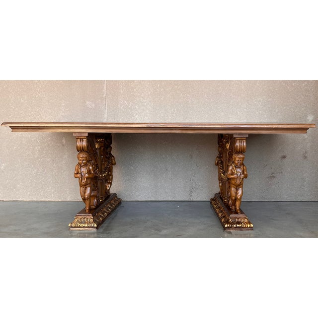 This elegant and large antique dining room table was crafted in France, circa 1900. Standing on a two carved scrolled...