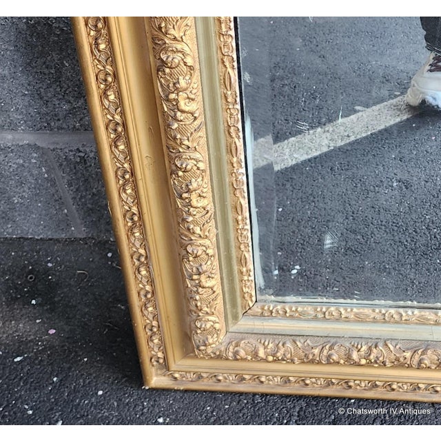 This is a great late Victorian era hanging mantel mirror, c1890s-1910. Gilt gesso on wood frame and painted gold. Some...