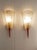 Pair of vintage wall sconces, authentic to the mid-20th century. Each sconce stands out with its textured white shade with...