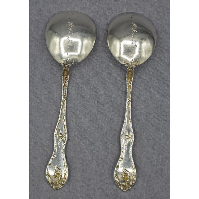 Pair of Reed & Barton sterling silver cream soup spoons. Cinq Fleurs pattern. Patent stamp May 22, 1900. Retailed by Morck...