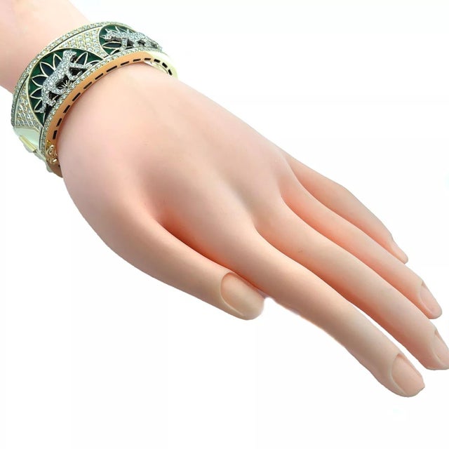 This is a large, impressive bracelet, it is well crafted from 14k yellow and white gold with a polished finish. The front...