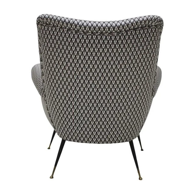 Armchair designed by Gigi Radice for Minotti with solid wood structure and metal legs. Upholstery in cotton with...