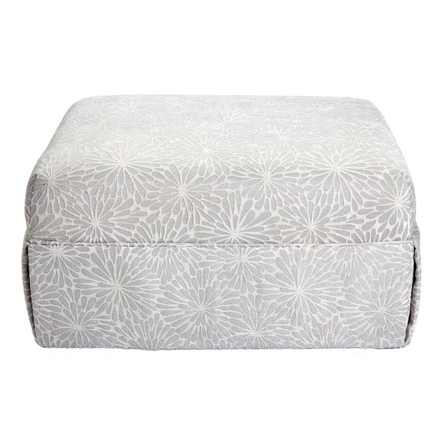 This large, rectangular ottoman has clean lines and a skirt which barely reveals the four wood block feet. A neutral...