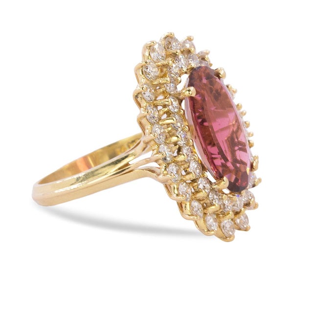 18k Ring with approximately 5.00 carat oval rubelite tourmaline and 45 round brilliant diamonds weighing approximately...