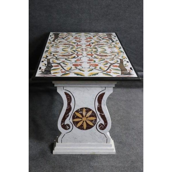 This Italian Neoclassical dining table is an extraordinary example of Pietra Dura craftsmanship, featuring a breathtaking...