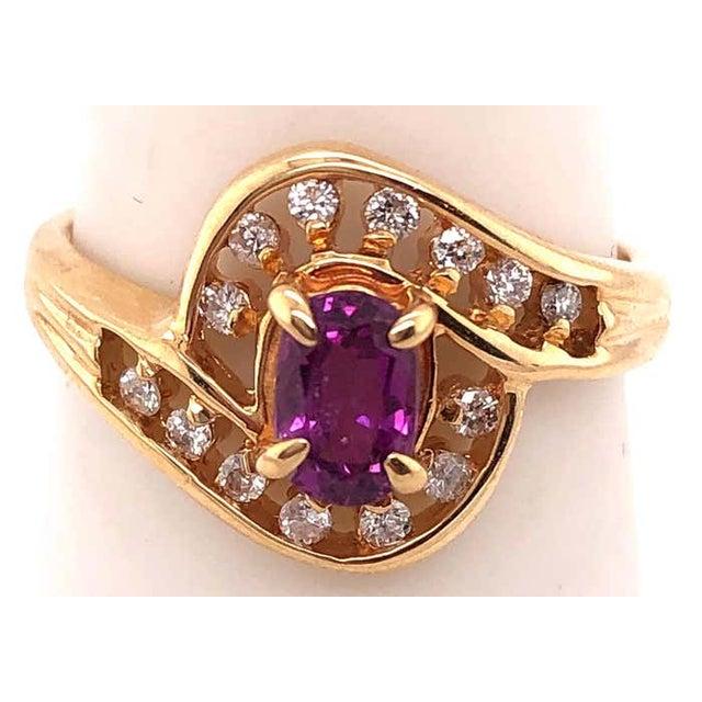 14 Karat Yellow Gold Purple Peridot Ring with Round Diamond Accents 0.14 TDW. Size 7.5 3.48 grams total weight.