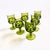 A set of 6 vintage goblets in an ornate design in green colored glass. Made in the King's Crown pattern by Indiana Glass....