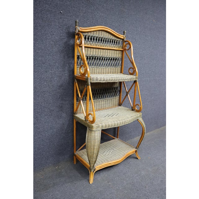Italian-style etagere constructed of bent bamboo with woven wicker shelves and back panels. Features decorative spiral-...