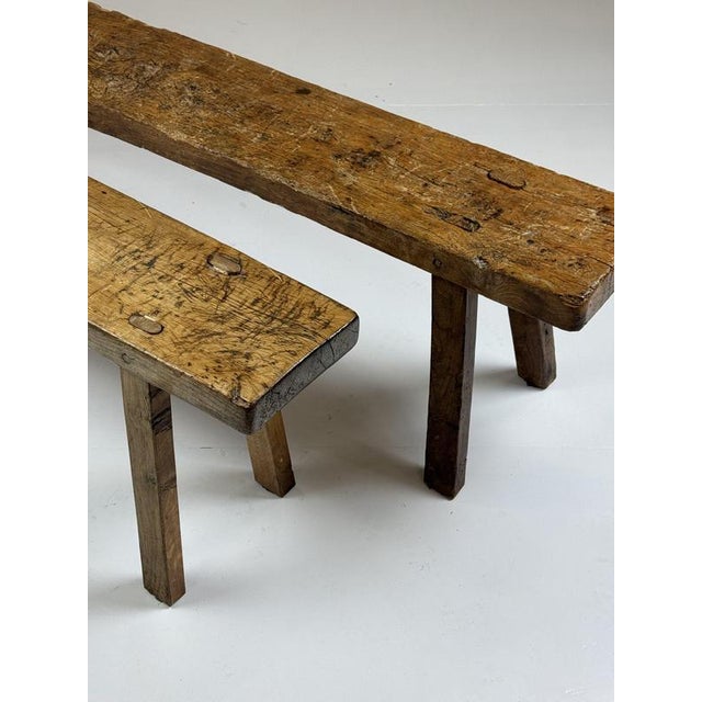 Two rustic dining benches. Made of solid oak. Sturdy and durable. Dimensions: 180L x 28D x 48.5H cm.
