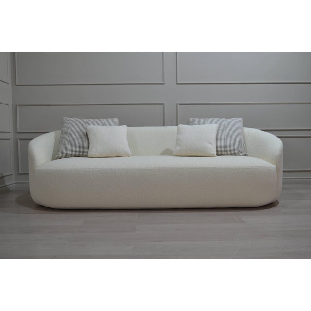 Sculptural Sofa — Ivory Bouclé That feels more appropriate for the Miami luxury-interior-designer market than simply...