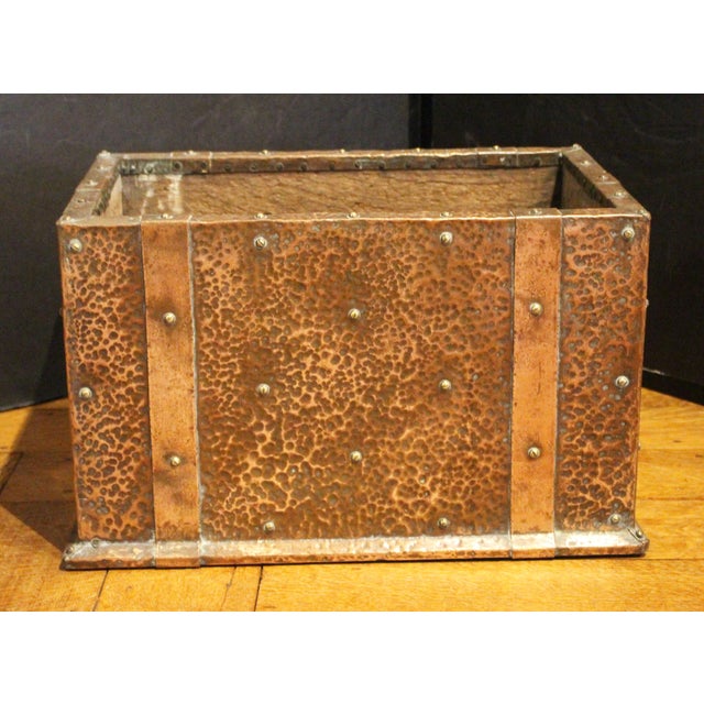 Circa 1880-1920 Arts & Crafts Copper Clad Kindling Bin, English. Oak with hammered copper clad surface & faux straps for...