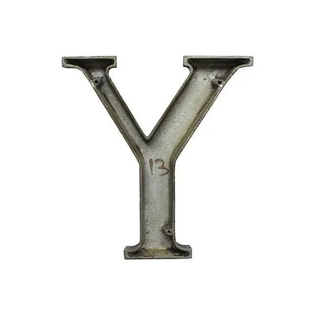 Mid-century aluminum sign letter Y with original black finish. Letter has wear from outside use, discolorations, chips in...