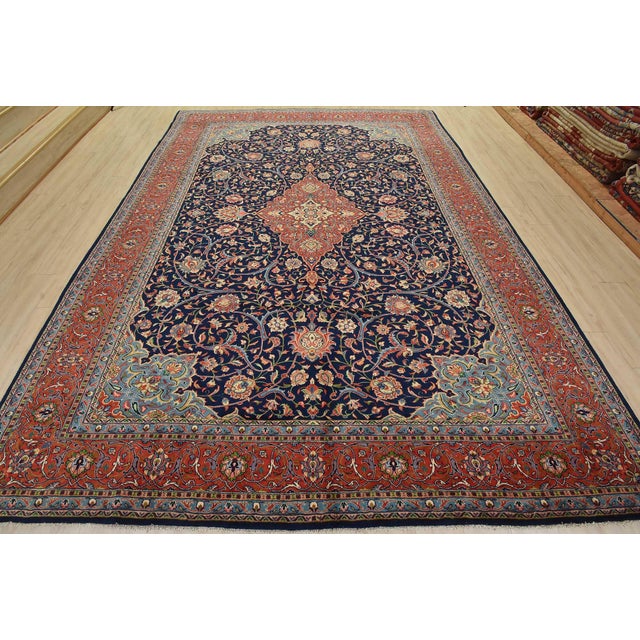 An authentic vintage traditional Sarouk rug hand-knotted with fine wool and natural dyes. This beautiful rug features a...