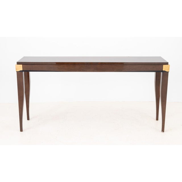 French Art Deco Style Satinwood Console Table, with highly lacquered top and gilt metal and ebonized accents atop tapered...