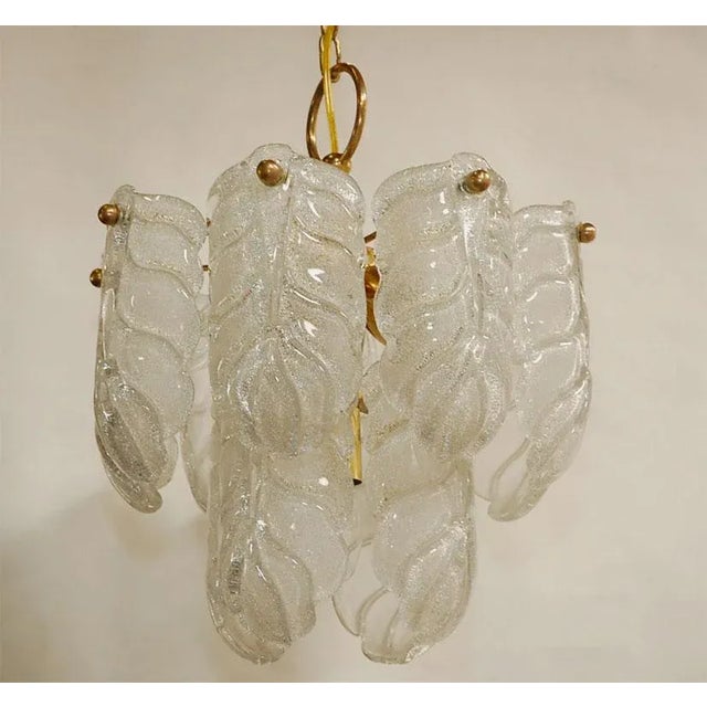 This nine light chandelier has a number of glass shades mounted in circular fashion on two levels. The overall effect is...