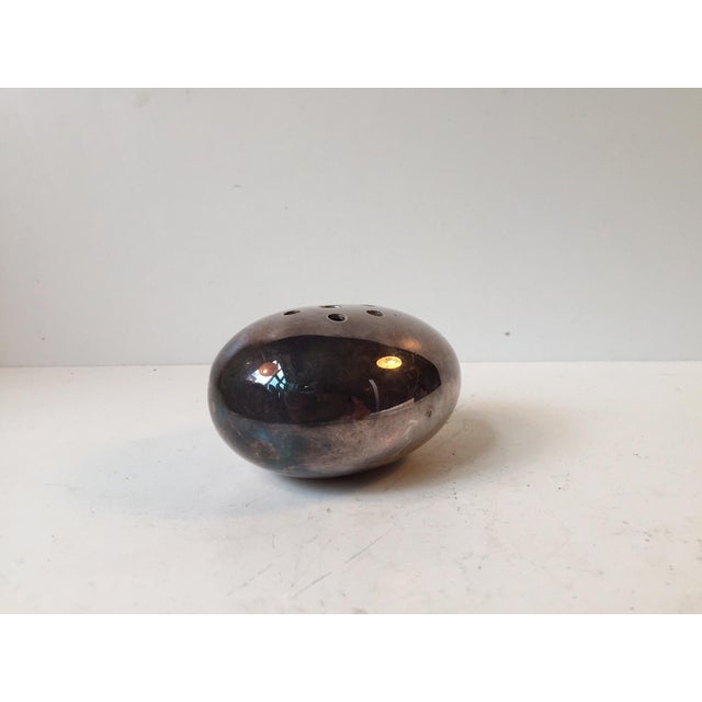 This egg-shaped flower vessel was designed and manufactured by Carl Cohr in Fredericia, Denmark during the 1950s. The...