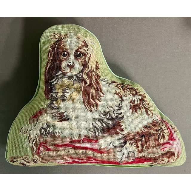 Needlepoint dog pillow of a King Charles Spaniel. Mounted on light green velvet back with self welt trim. Measures 14"...