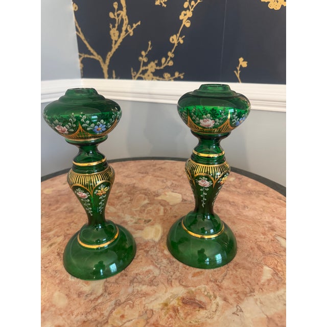 A striking and refined pair of vintage Bohemian glass candlesticks, rendered in a rich emerald green and exquisitely hand-...
