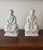 A intricate pair of vintage porcelain Blanc de Chine-style Buddha figures, each rendered in a classic seated meditation...