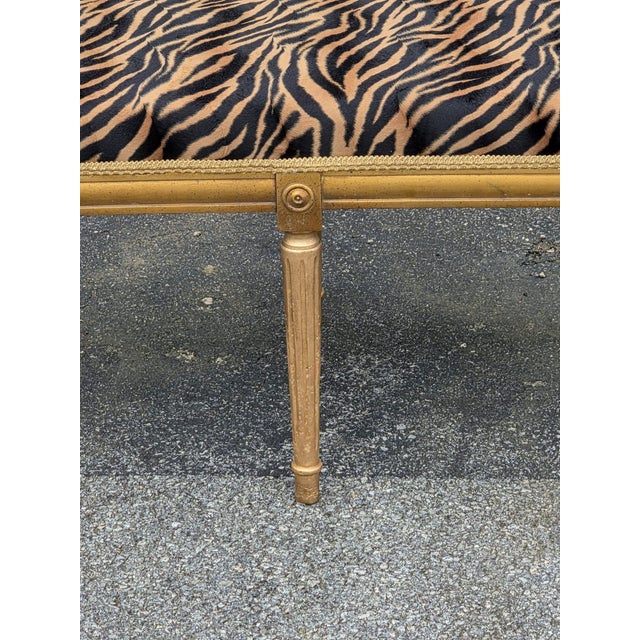 Stunning Italian-style upholstered bench featuring an eye-catching zebra print fabric and beautifully detailed gold-tone...