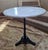 French bistro table with polished marble top and cast iron pedestal base. These were commonly found outside cafes and...