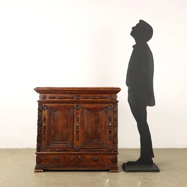 Baroque sideboard in chestnut and walnut, central Italy, early 18th century. Opening top, paneled front. The piece of...