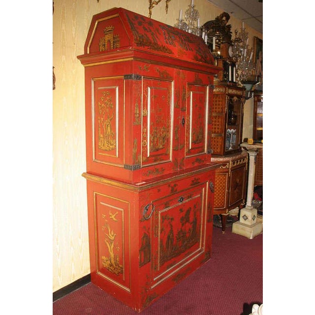 A very fine bookcase with unusual chinoiserie style decoration and code of arm. Applied wrought iron mounts. Stock number: .