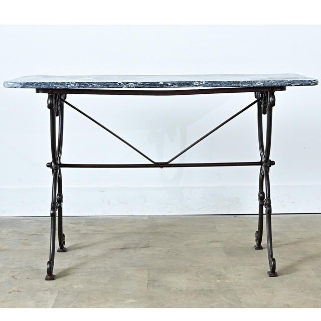 An exceptional 19th century rectangular French bistro table with fabulous design elements throughout. The marble slab has...