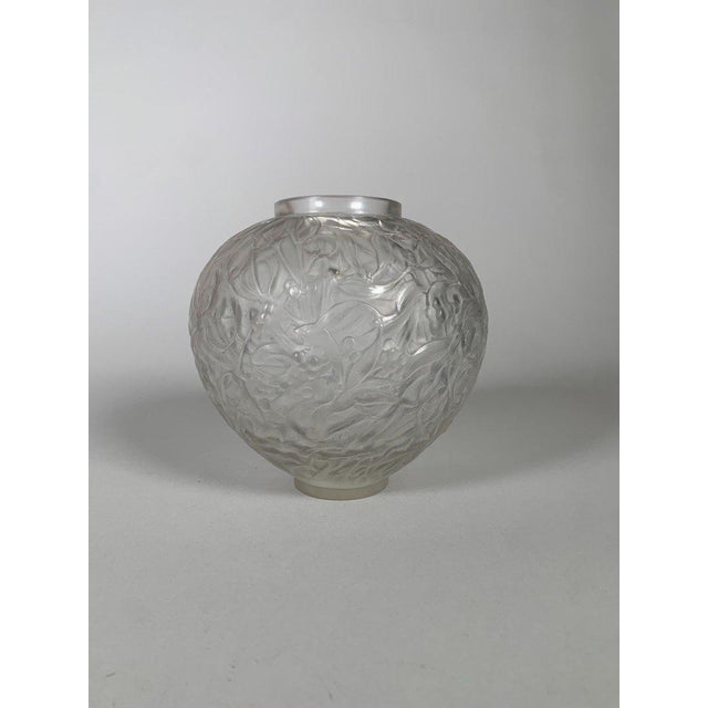 René Lalique (1860-1940) "Gui" (Milk) Vase in Glass. White blown and molded glass vase with a motif of intertwined...