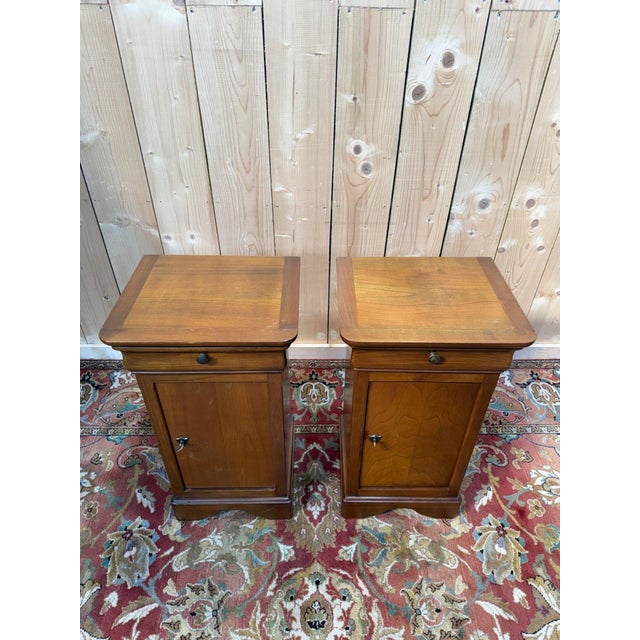 A magnificent pair of Louis Philippe style bedside tables dating from the mid-20th century. These elegant solid wood...