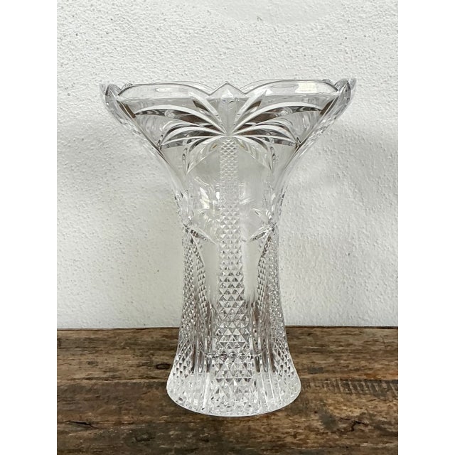 This vintage crystal vase captures a coastal spirit through its intricately cut palm tree motif, with sharply engraved...