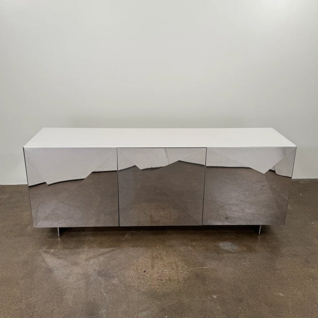 The Cubric sideboard's geometric design celebrates the interplay of form and line, enhanced by carefully processed steel...