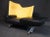 This incredible "Torso" chaise sofa by Paolo Deganello pairs black leather with yellow upholstery in a striking design in...