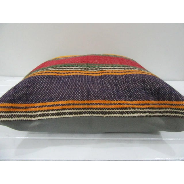 This is a pillow cover made from a vintage kilim rug. The piece was properly washed and ready to use. Pillow inserts not...