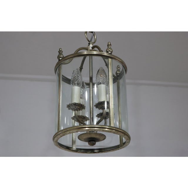 An elegant Italian Empire Style lantern pendant lamp, designed by Gaetano Sciolari and produced in Italy, circa 1960–1970....