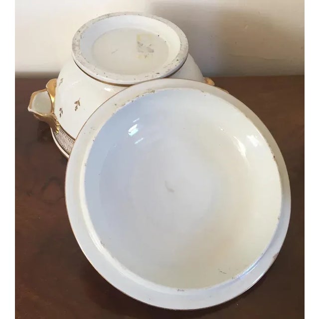 Antique early 19th c. Coalport porcelain round tureen or covered bowl with dolphin mask handles. Decorated in gold with an...