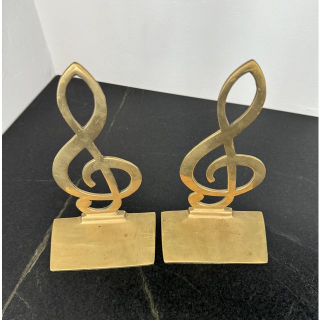 A wonderful pair of hand crafted, solid brass bookends. The musical clef design stands just over 7.5" tall. Lovely patina!